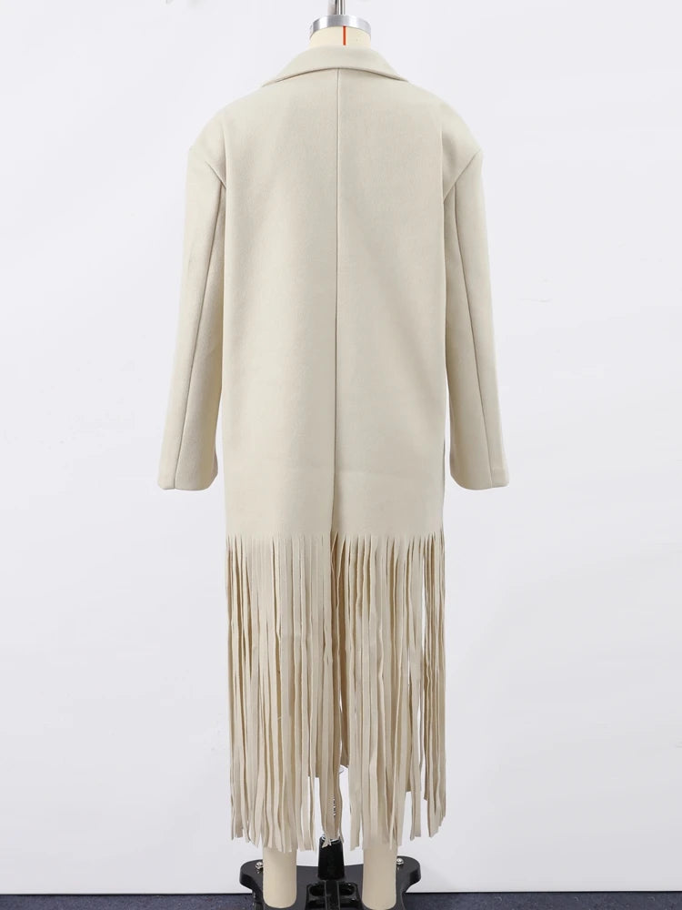 Beige cardigan with fringe details on a mannequin against a white background