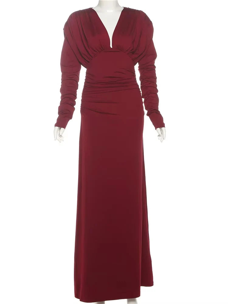 Maroon evening gown on a mannequin against a white background