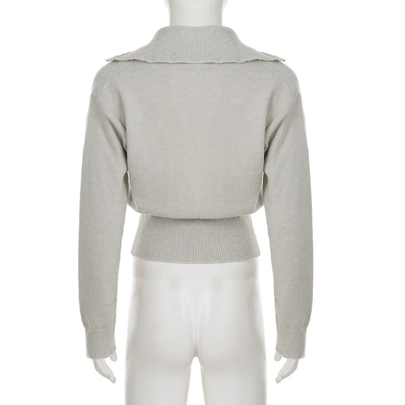 Rear view of knitted pullover showing smooth shoulder line and lightweight knit shaping