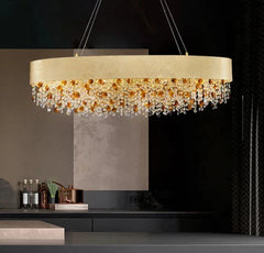 Modern chandelier with crystal accents hanging above a dark countertop.