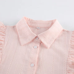 Close-up of a pink blouse with a collar on a light gray background