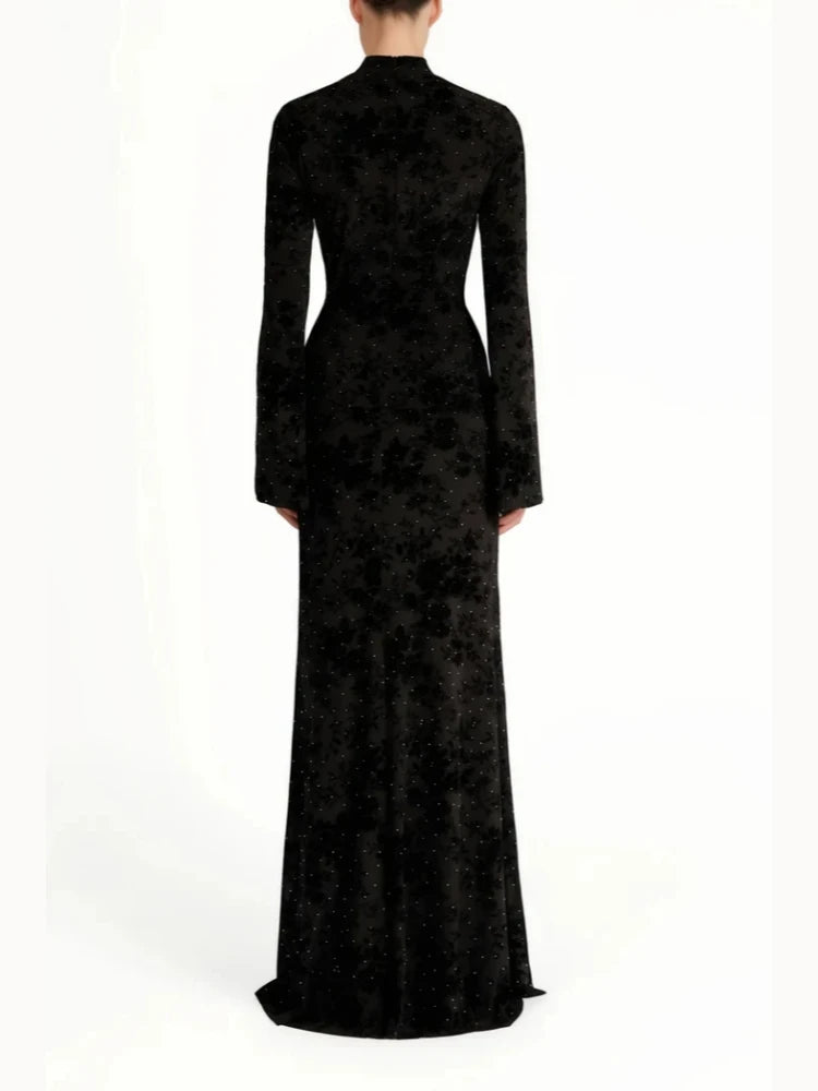 Black evening gown with long sleeves on a white background