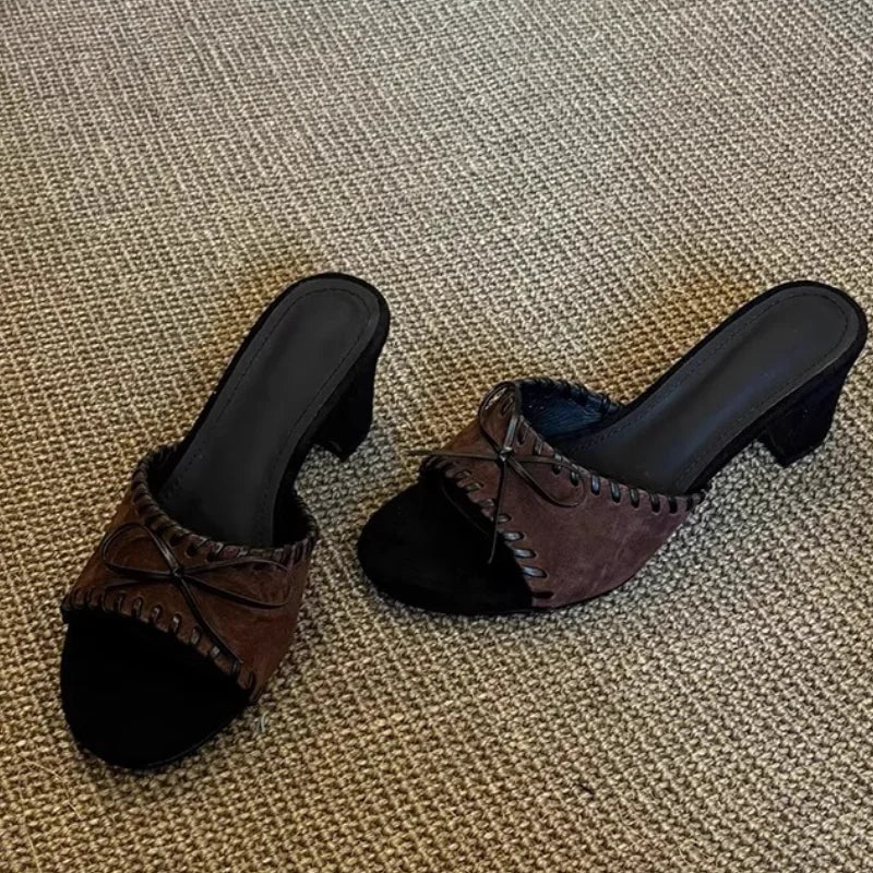 Brown open toe square heel mules with stitched trim and bow detail