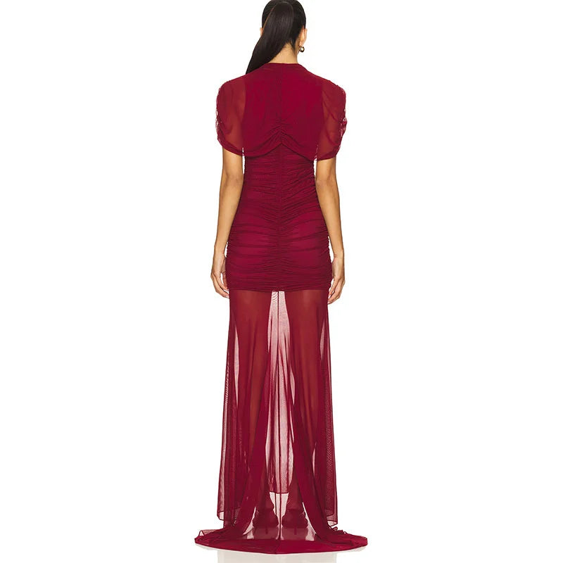 Red evening gown with sheer overlay on a white background