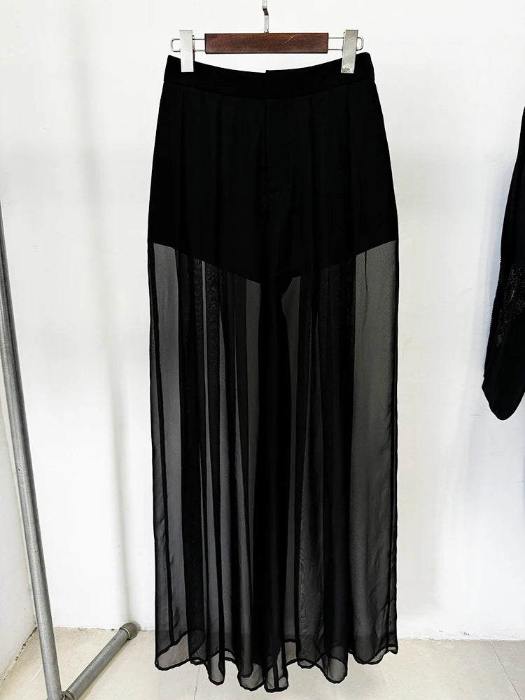 Black skirt with sheer overlay on a hanger against a white background