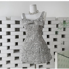 Silver sequin mini dress with bow detail on a mannequin