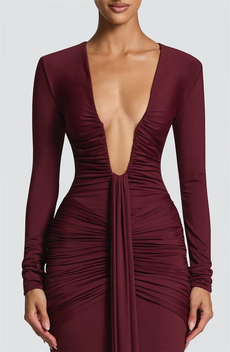 Maroon dress with long sleeves and a deep neckline on a white background