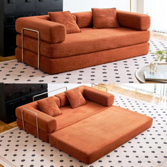 Orange sofa bed in a living room setting with a patterned rug.