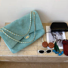 Light blue quilted suede flap shoulder bag with accessories