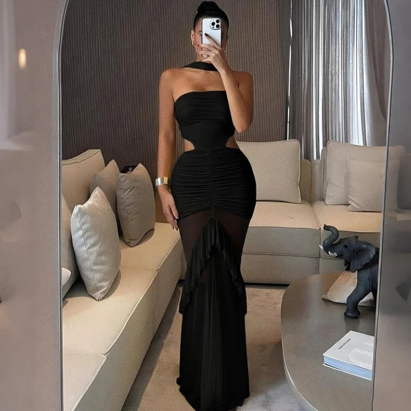 Person wearing a black dress in a modern living room.