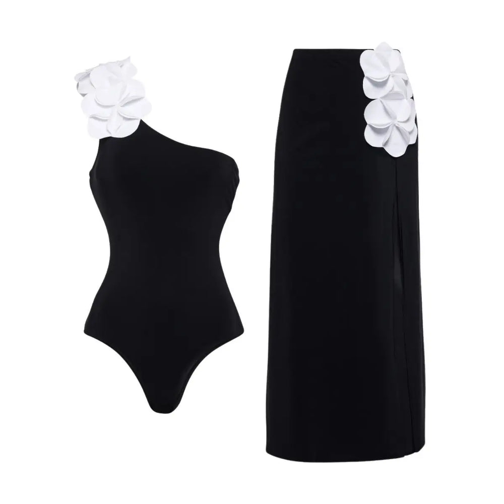 One-shoulder swimsuit with white floral appliqués and matching high-waist maxi skirt