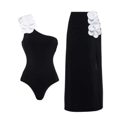One-shoulder swimsuit with white floral appliqués and matching high-waist maxi skirt