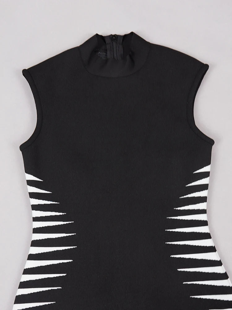 Black sleeveless dress with white geometric patterns on a light gray background