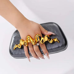 Sculptural wave handle clutch bag with black acrylic exterior