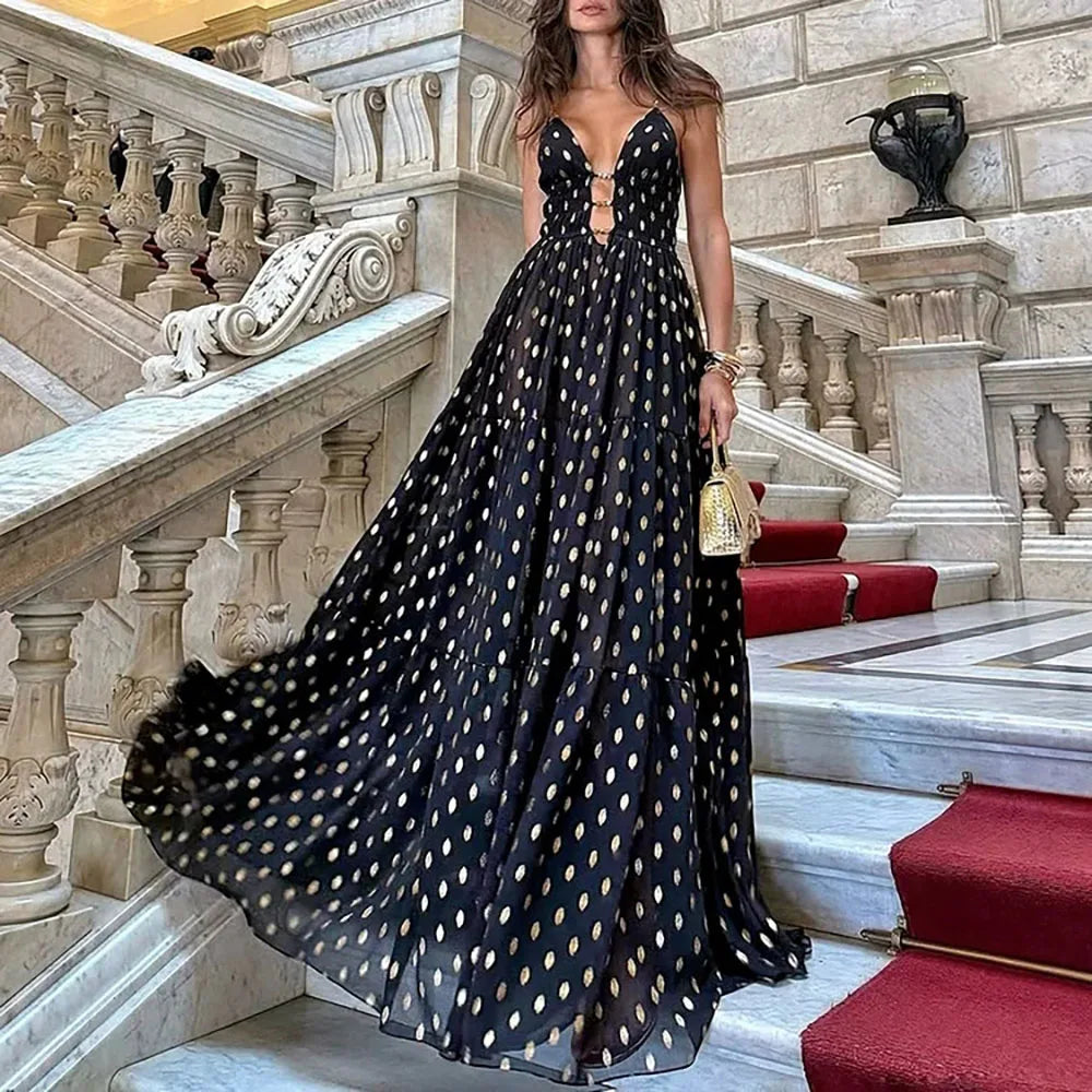 Full view of a woman wearing a black and gold polka dot maxi Skirt