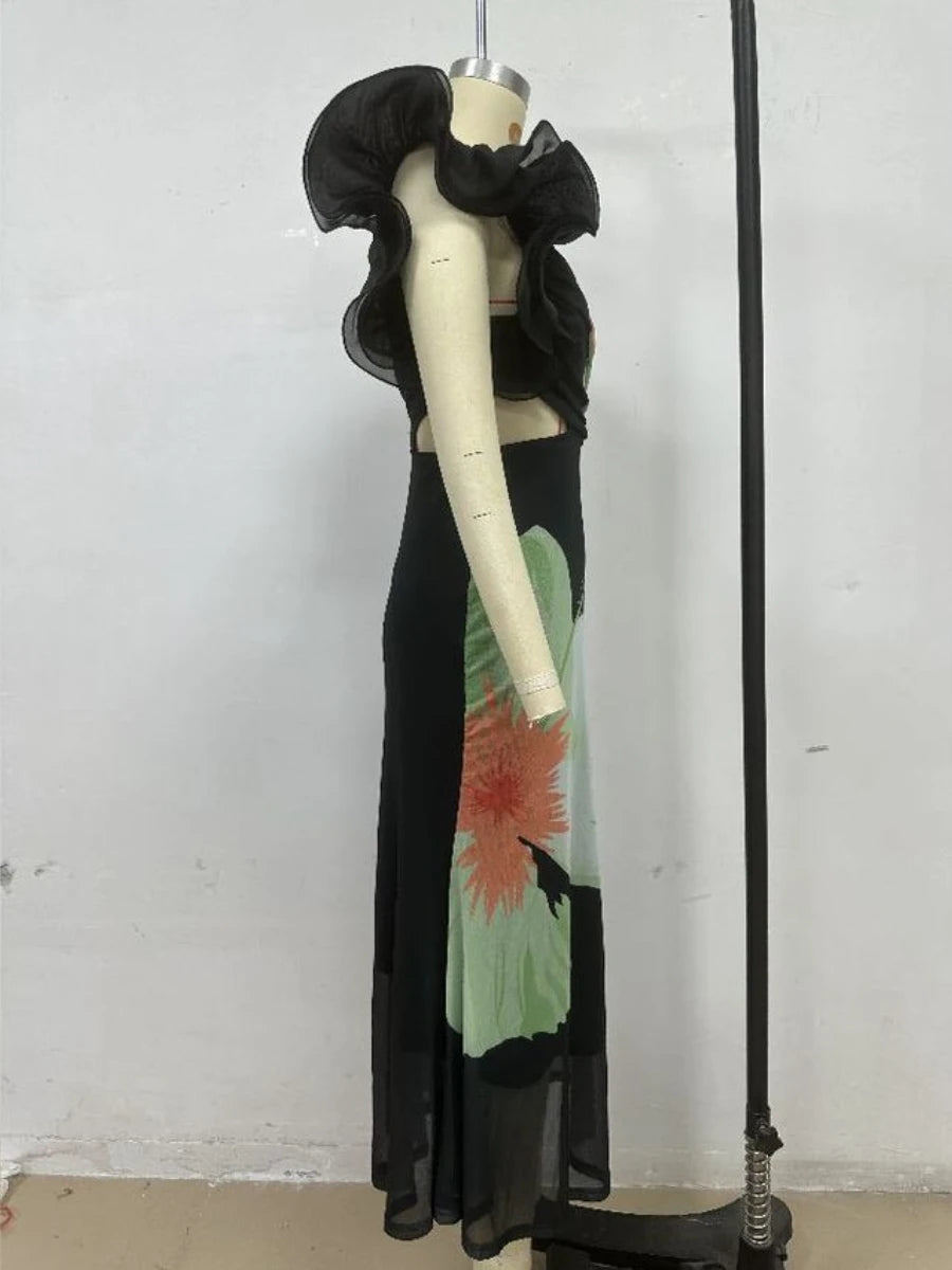 Mannequin wearing a black dress with floral design against a white background