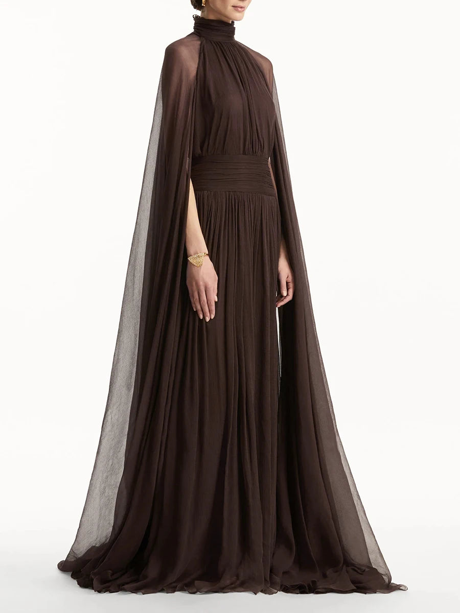 Brown evening gown with a sheer cape on a white background