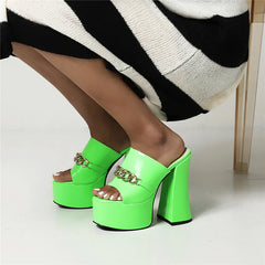 Green chunky heel platform slides with metal chain detail