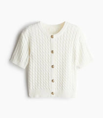 White textured cardigan with button details on a white background