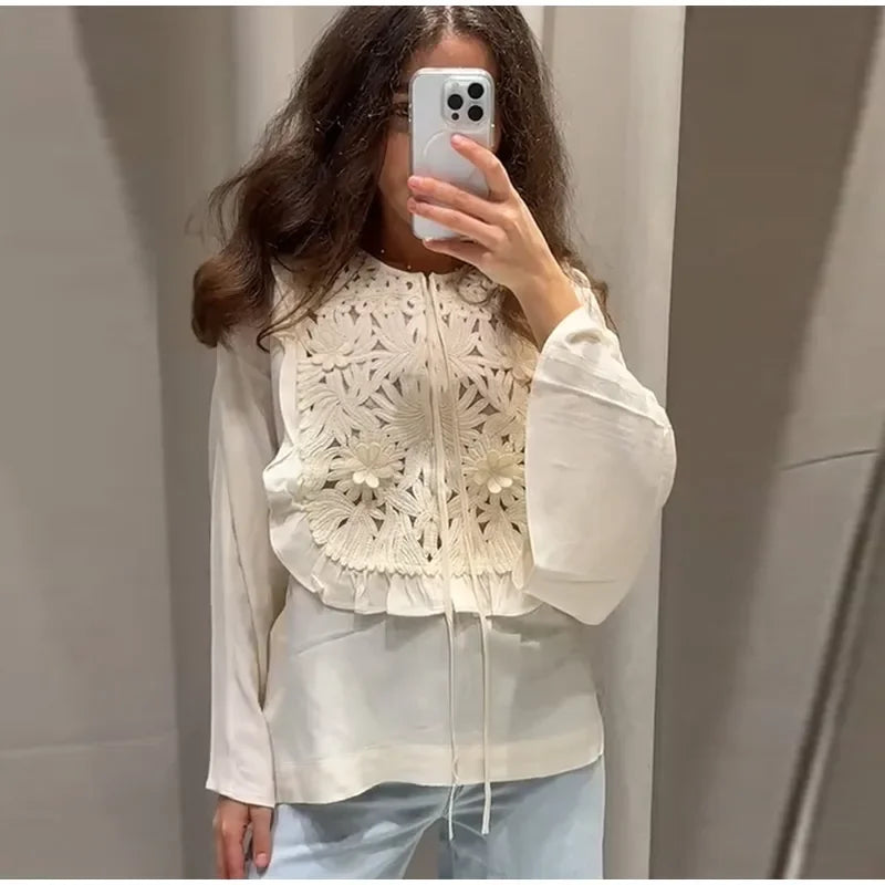 Close-up of floral embroidery on the blouse.