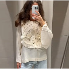 Close-up of floral embroidery on the blouse.