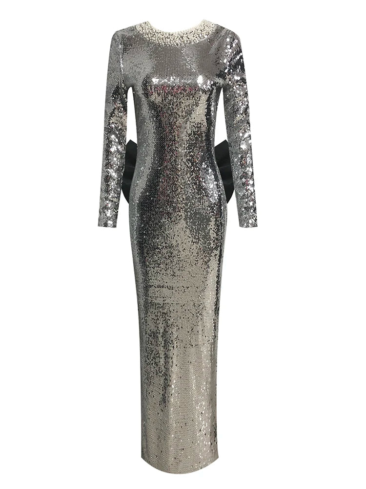Silver sequin dress with long sleeves on a white background