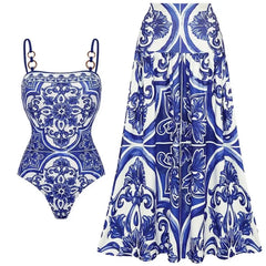 Blue and white tile print one-piece swimsuit and maxi skirt set laid flat.