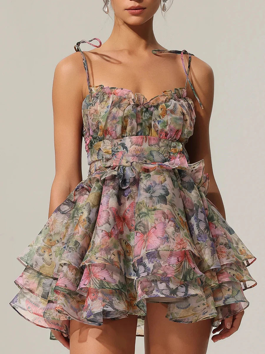 Woman wearing a floral dress against a neutral background