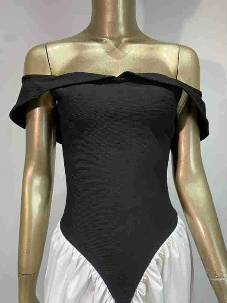 Black off-shoulder top on a gold mannequin against a white background
