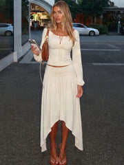 Cream off shoulder long sleeve crop top and asymmetrical hem midi skirt two-piece set