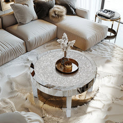 Round coffee table with decorative items in a living room setting