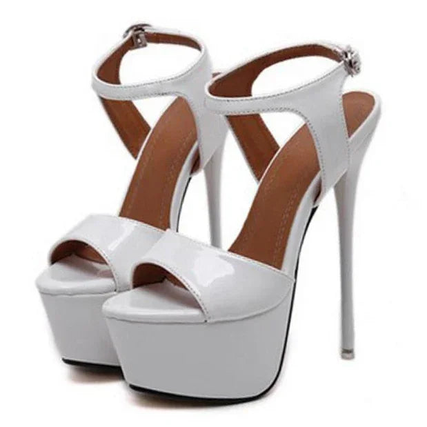 White high-heeled platform sandals with brown straps on a white background