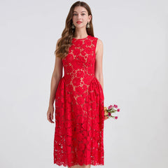 Woman wearing a red lace dress holding flowers on a white background