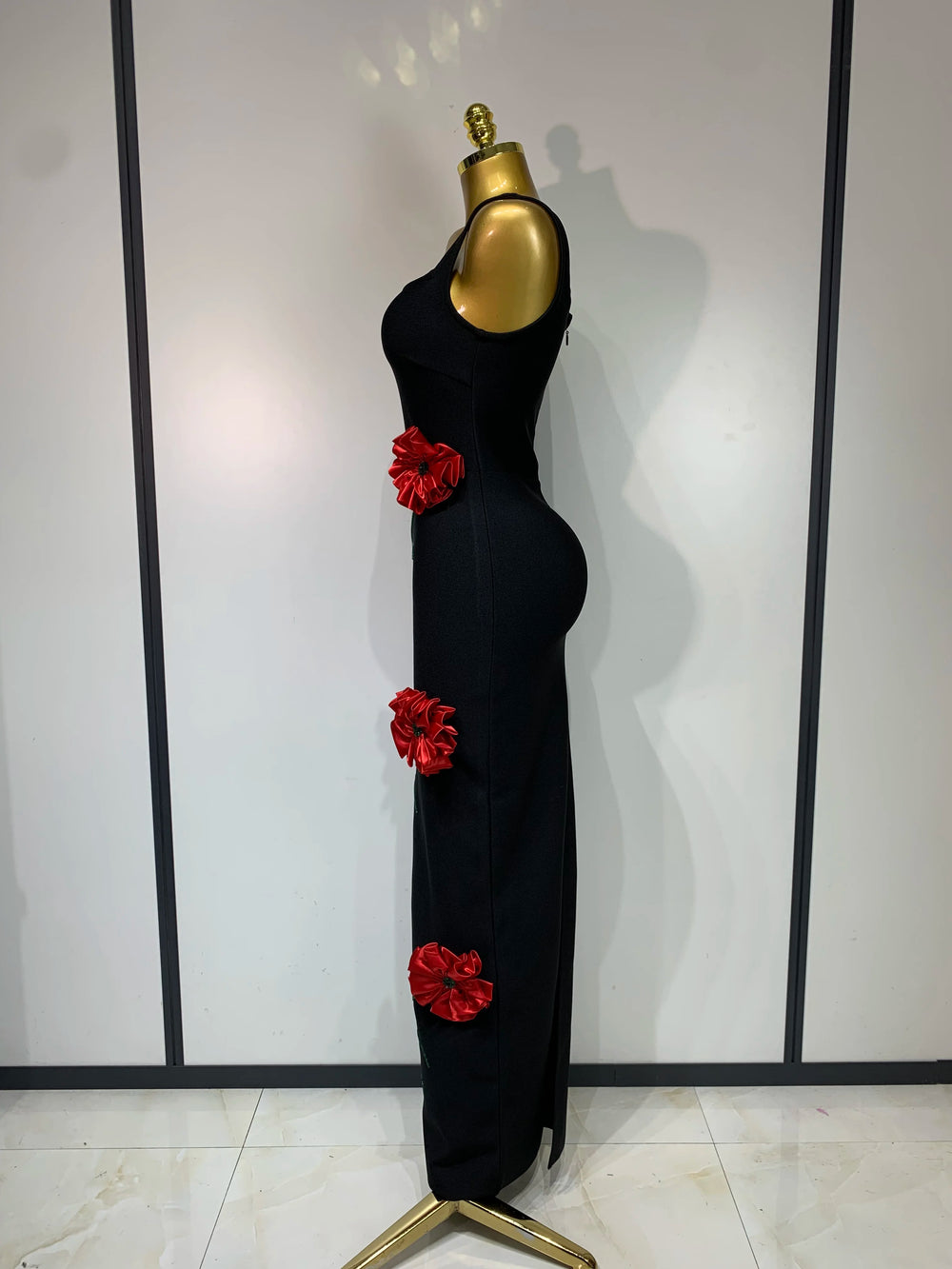 Back view of a black body-skimming gown with sleeveless design.