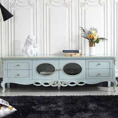 Light blue entertainment console with decorative elements in a room with white walls and black rug.
