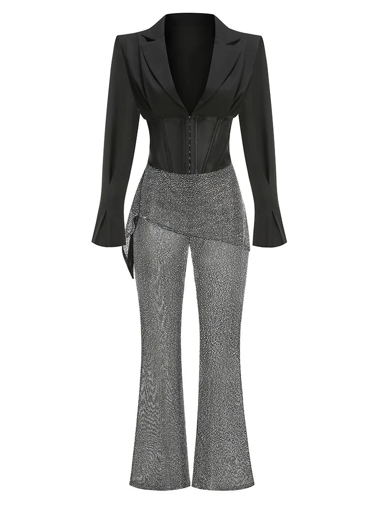 Black blazer and gray patterned pants on a white background