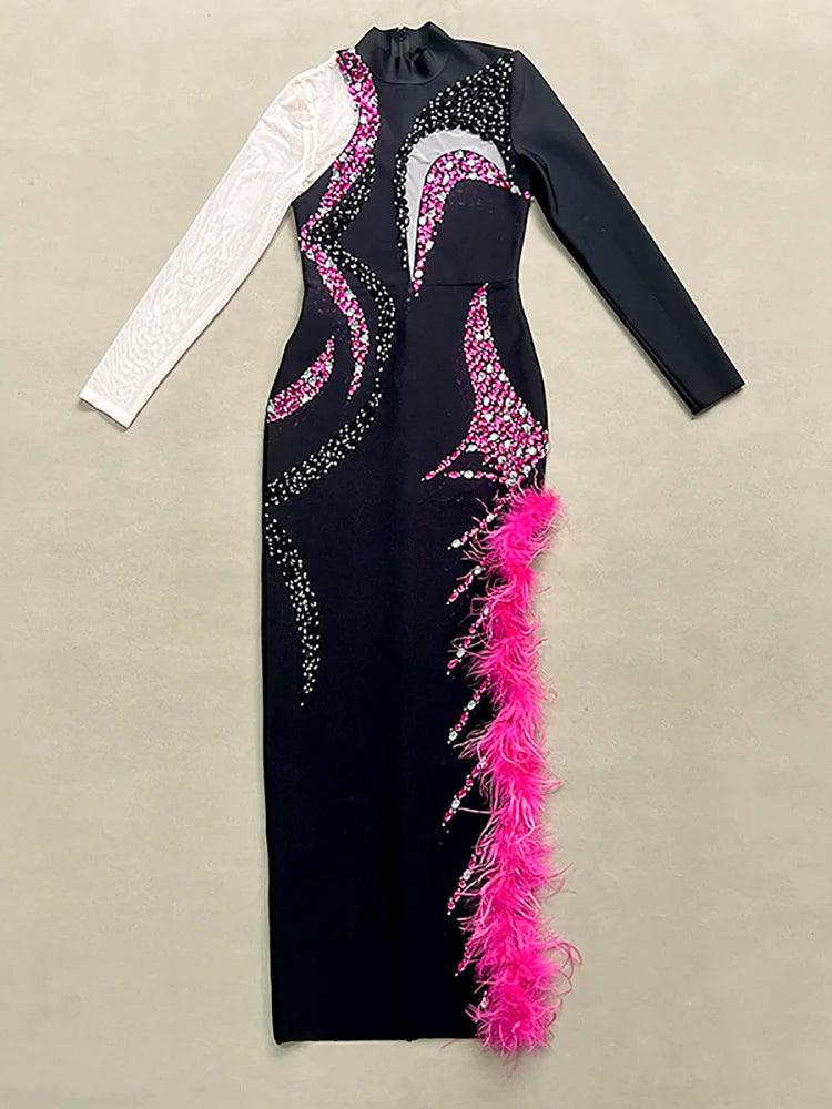 Black dress with pink feather details on a beige background