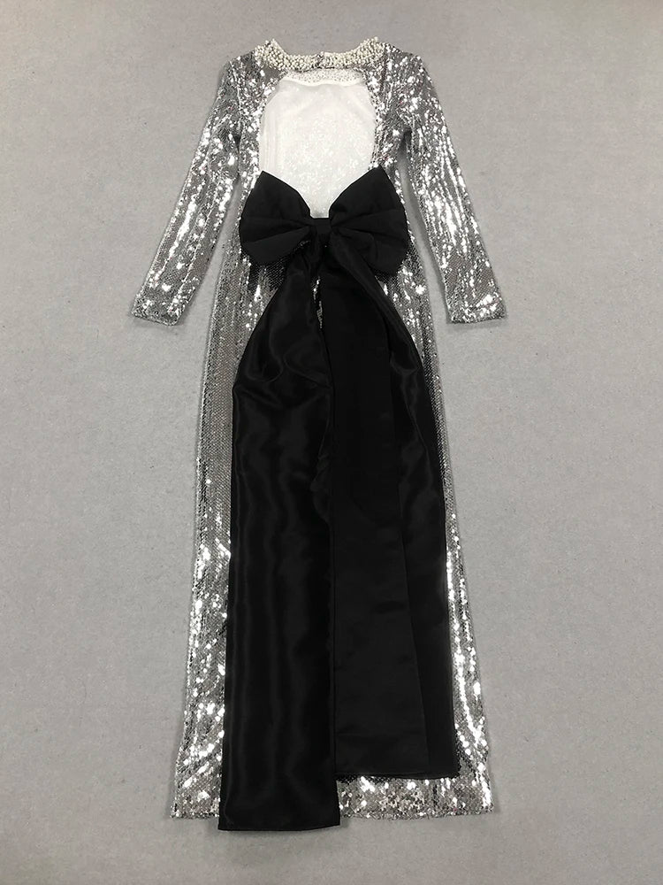 Black dress with silver sequin overlay on a gray background