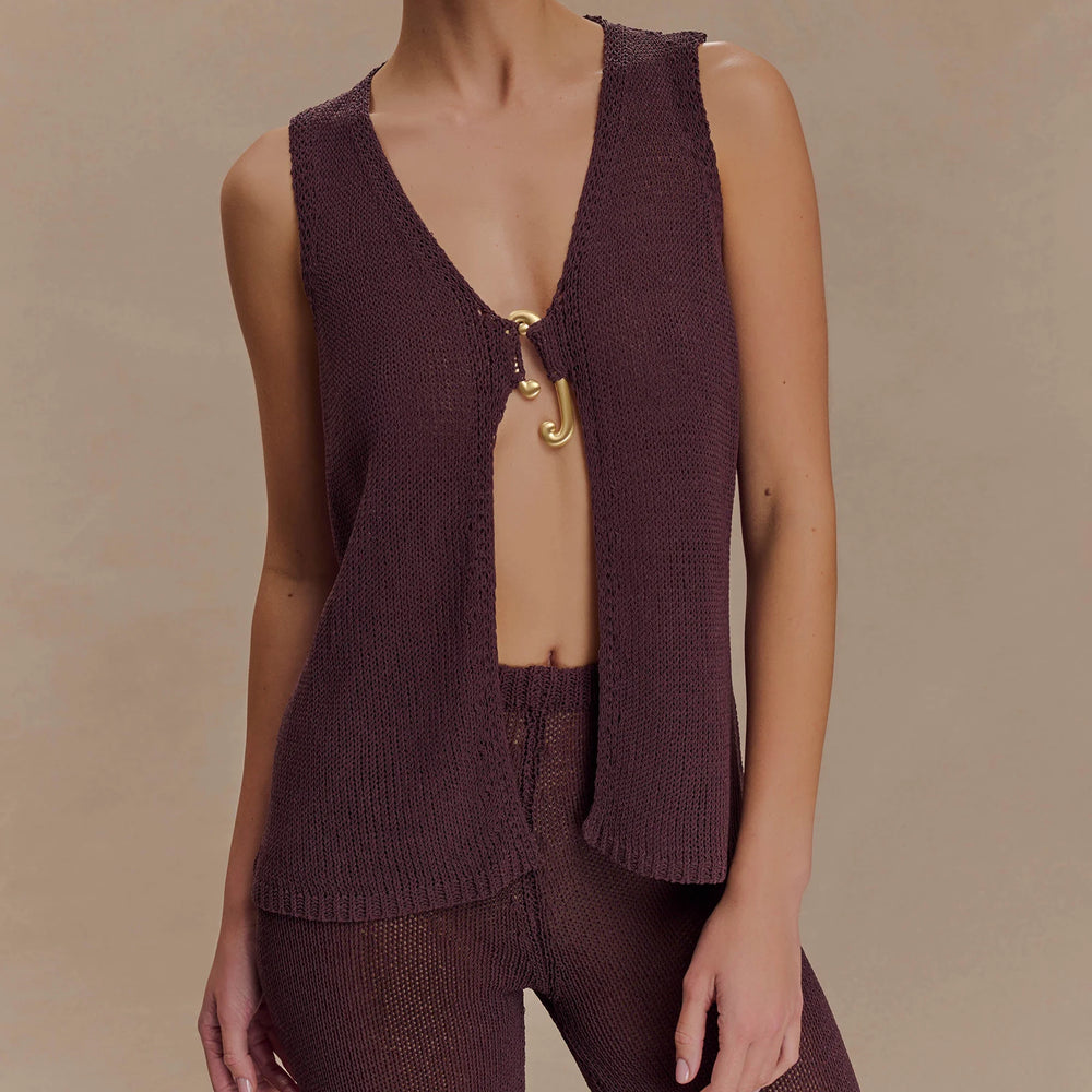 Brown knitted vest with open back on a neutral background