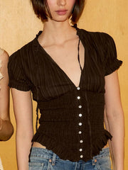 Detail of smocked peplum blouse with button front