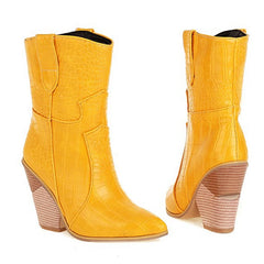 Pair of yellow cowboy boots with a textured pattern on a white background