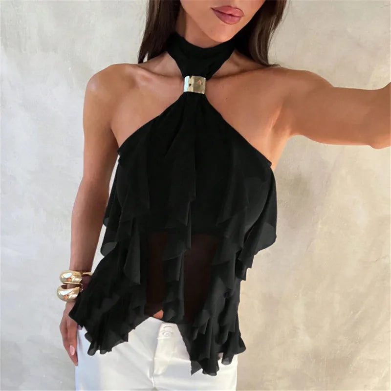 Black halter top with ruffled details worn by a model against a neutral background