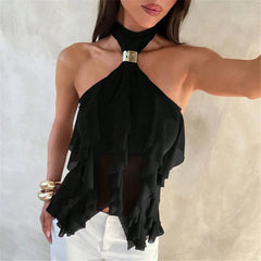 Black halter top with ruffled details worn by a model against a neutral background