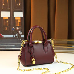 Structured leather top-handle bag with gold hardware and chain strap