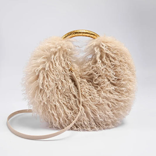 Close-up of the curly texture of the beige faux fur bag.