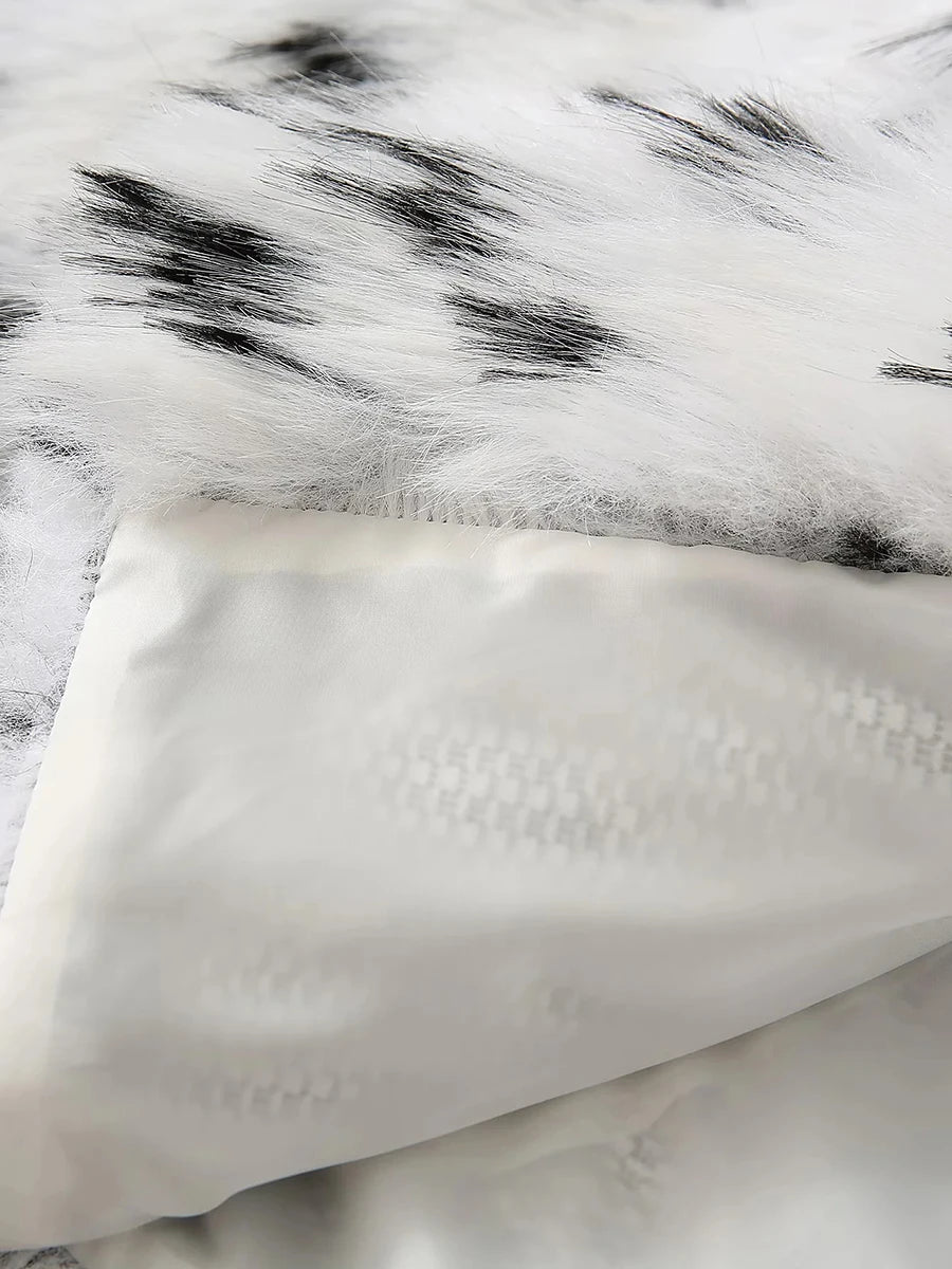 Close-up of a textured white surface with black speckles