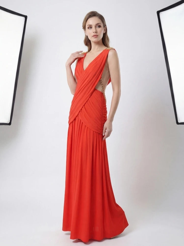 Woman wearing a red evening gown against a white background