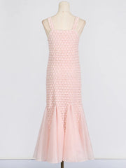 Pink ruffled dress on a mannequin against a white background