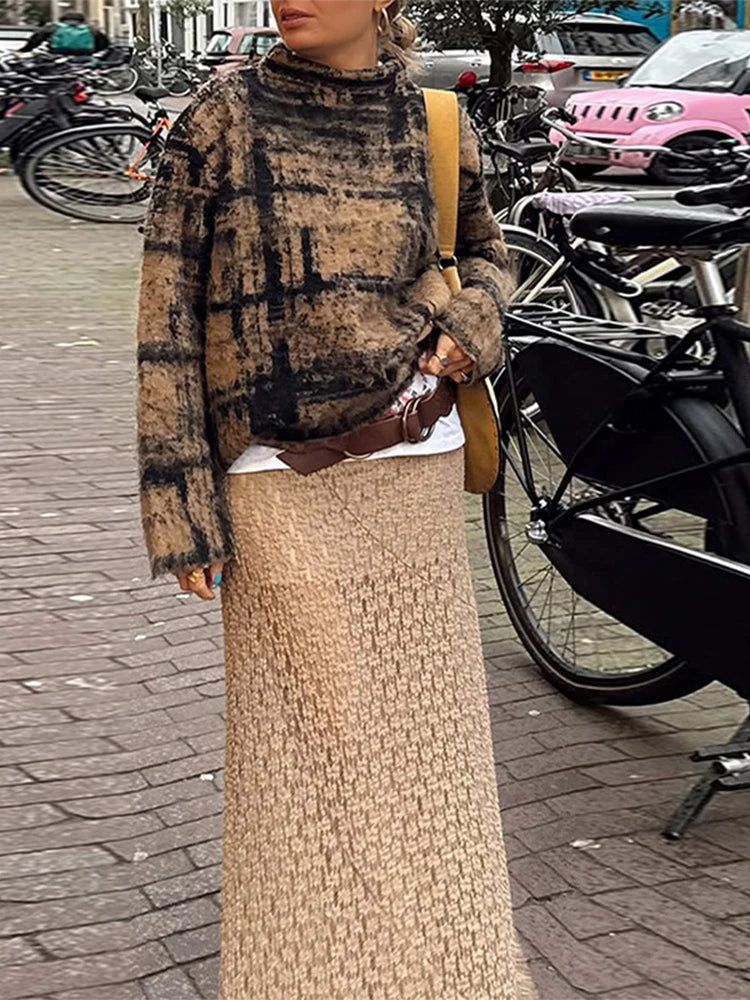 Person wearing a plaid sweater and beige skirt in an urban setting with bicycles and cars.