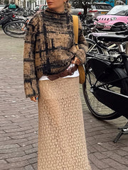 Person wearing a plaid sweater and beige skirt in an urban setting with bicycles and cars.